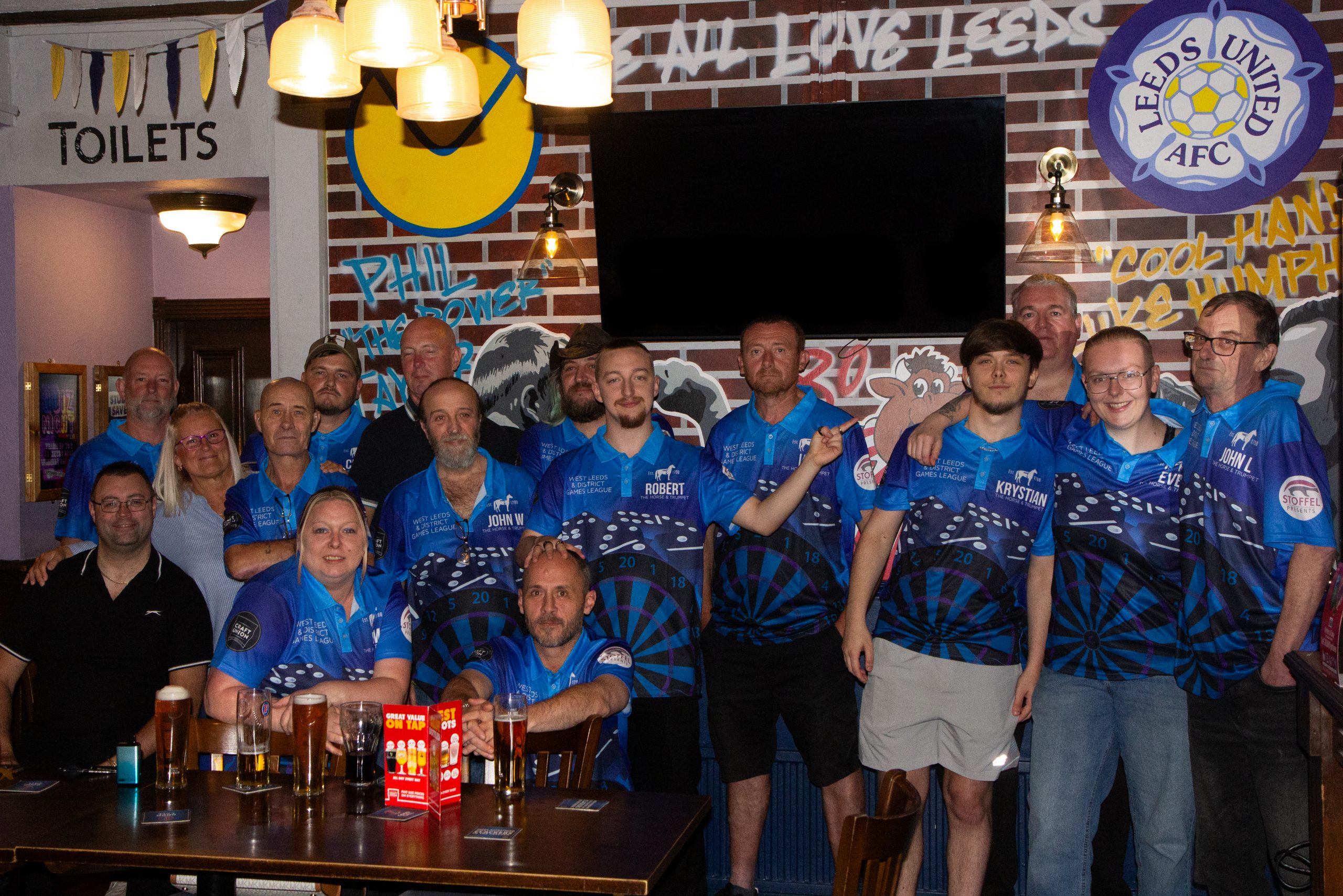 Horse and Trumpet games team in an ensemble photo with every member wearing team uniform